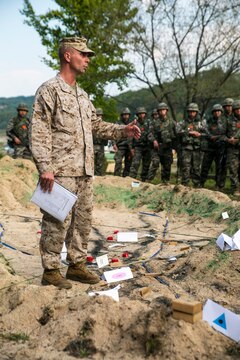 U.S. Marine Capt. Christopher Frey, from Dickinson, Texas, discusses a battle plan with Republic of Korea and U.S. Marines Oct. 7 at Rodriguez Live Fire Complex during Korean Marine Exchange Program 14-13. The unit leaders prepared themselves for the combined live-fire event by testing the basic infantry skills of their Marines throughout the previous weeks. Frey is a fire support coordinator with 1st Battalion, 3rd Marine Regiment, currently assigned to 4th Marine Regiment, 3rd Marine Division, III Marine Expeditionary Force, under the unit deployment program. 