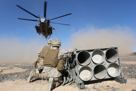 Marines with Combat Logistics Battalion (CLB) 13 wait as a CH-53E Super Stallion with Marine Heavy Helicopter Squadron (HMH) 462 prepares to lift a decommissioned rocket pod aboard Marine Corps Air Station Yuma, Ariz., Oct. 23. The training helped the Marines experience the effects of the aircraft while trying to attach the cargo.