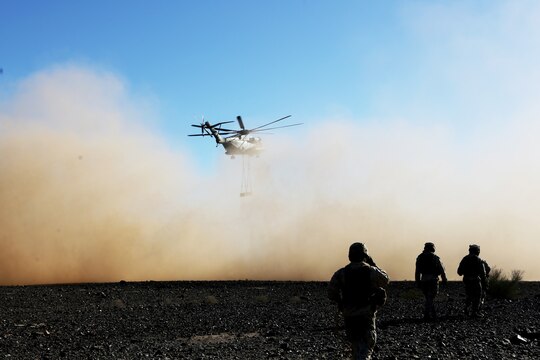 Marines with Combat Logistics Battalion (CLB) 13 watch as a CH-53E Super Stallion with Marine Heavy Helicopter Squadron (HMH) 462 carries simulated cargo during a training exercise aboard Marine Corps Air Station Yuma, Ariz., Oct. 23. The training allows Marines to be mission ready and prepared to respond at a moment’s notice.