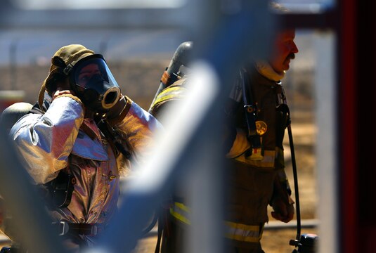 Firefighters dress in flame resistant suits and oxygen tanks in preparation for an exercise conducted by the Camp Pendleton Fire Department and the Marine Corps Air Station Camp Pendleton’s Aircraft Rescue Fire Fighting unit on a controlled burn training facility at the 25 Area here.
The training was designed to teach firefighters how to prevent rapid combustion of burned materials in rooms and structures.
