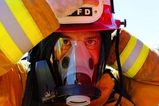 Firefighters dress in flame resistant suits and oxygen tanks in preparation for an exercise conducted by the Camp Pendleton Fire Department and the Marine Corps Air Station Camp Pendleton’s Aircraft Rescue Fire Fighting unit on a controlled burn training facility at the 25 Area here.
The training was designed to teach firefighters how to prevent rapid combustion of burned materials in rooms and structures.
