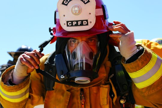 Firefighters dress in flame resistant suits and oxygen tanks in preparation for an exercise conducted by the Camp Pendleton Fire Department and the Marine Corps Air Station Camp Pendleton’s Aircraft Rescue Fire Fighting unit on a controlled burn training facility at the 25 Area here.
The training was designed to teach firefighters how to prevent rapid combustion of burned materials in rooms and structures.
