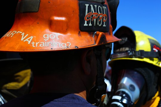 Firefighters file into a training facility during an exercise conducted by the Camp Pendleton Fire Department and the Marine Corps Air Station Camp Pendleton’s Aircraft Rescue Fire Fighting unit on a controlled burn training facility at the 25 Area here.
“This is a Flashover simulator,” said Rick Clarke, a train-the-trainer instructor for Fire Training Structures. “This teaches firefighters how to prevent the rapid combustion of off-gas created by burned materials.”
