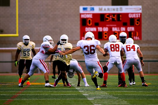 Eli Spallinger, punter with the 1st Light Armored Reconnaissance Battalion Highlanders, punts the ball during a game where the Highlanders claimed a 20-14 victory over the Headquarters and Support Battalion Spartans at the Paige Fieldhouse football field here, Sept. 8.