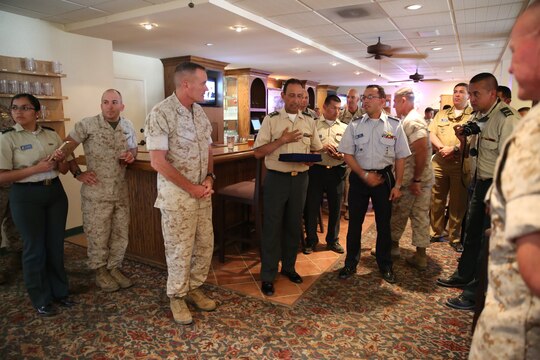 Brig. Gen. Leonardo Pinto Morales, commander of the 7th Division of the Colombian Army, presents Major Gen. Vincent A. Coglianese, 1st Marine Logistics Group commanding general, with a gift as part of the Colombian Observance Exchange Program Sept. 2, 2014, aboard Camp Pendleton, Calif. More than thirty officers of the Colombian School of Advanced Warfighting visited 1st MLG to allow members of both the U.S. Marine Corps and Colombian Armed Forces to build an understanding of services, share best practices and strengthen camaraderie and interoperability. (U.S. Marine Corps photo by Staff Sgt. Lynn Kinney/released)