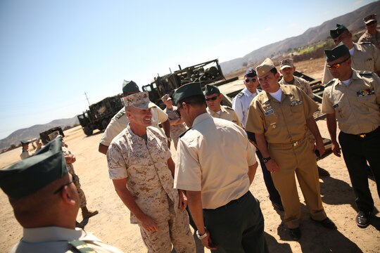 Major Gen. Vincent A. Coglianese, 1st Marine Logistics Group Commanding General, speaks with Brig. Gen. Leonardo Pinto Morales, commander of the 7th Division of the Colombian Army, during the Colombian Observance Exchange Program Sept. 2, 2014, aboard Camp Pendleton, Calif. More than thirty officers of the Colombian School of Advanced Warfighting visited 1st MLG to allow members of both the U.S. Marine Corps and Colombian Armed Forces to build an understanding of services, share best practices and strengthen camaraderie and interoperability. (U.S. Marine Corps photo by Sgt. Laura Gauna/released)