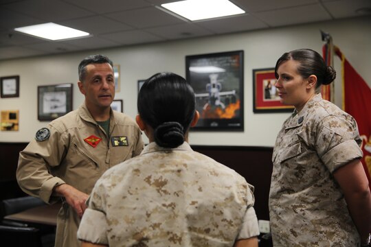 Maj. Gen. Michael Rocco, commanding general of 3rd Marine Aircraft Wing, speaks with Petty Officer 2nd Class Samantha Sanchez, a corpsman with Marine Aviation Logistics Squadron (MALS) 11 after recently receiving the Junior Enlisted Women of the Year award aboard Marine Corps Air Station Miramar, Calif., March 31. She was one of two 3rd Marine Aircraft Wing Sailors to receive the award this year.
