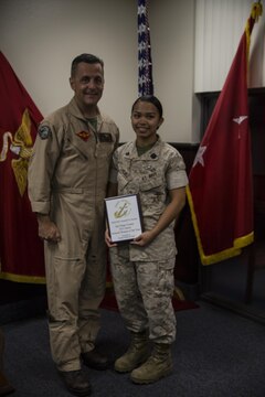 Petty Officer 2nd Class Samantha Sanchez, a corpsman with Marine Aviation Logistics Squadron (MALS) 11, stands with Maj. Gen. Michael Rocco, commanding general of 3rd Marine Aircraft Wing, after recently receiving the Junior Enlisted Women of the Year award aboard Marine Corps Air Station Miramar, Calif., March 31. She was one of two 3rd Marine Aircraft Wing Sailors to receive the award this year.