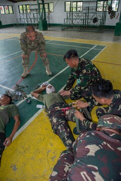 Armed Forces of the Philippines Army Soldiers attend to a casualty while U.S. Army Spc. Neil Bautista, assigned to the 97th Civil Affairs Battalion, observes at a simulated mass casualty exercise in Jamindan, Philippines, during Balikatan 2015, April 9. The exercise was part of a cooperative health engagement, train-the-trainer first responder course at the headquarters of the AFP’s 3rd Infantry Division, attended by AFP Soldiers and civilian personnel from the Capiz Emergency Response Team. Balikatan, which means “shoulder to shoulder” in Filipino, is an annual bilateral training exercise aimed at improving the ability of Philippine and U.S. military forces to work together during planning, contingency, humanitarian assistance and disaster relief operations. 