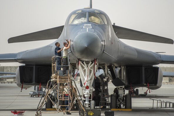 Crew chiefs prepare a B-1B Lancer on Al Udeid Airbase, Qatar, for combat operations against Islamic State of Iraq and the Levant terrorists, April 8, 2015. Al Udeid is a strategic coalition air base in Qatar that supports over 90 combat and support aircraft and houses more than 5,000 military personnel.  (U.S. Air Force photo/Senior Airman James Richardson) 