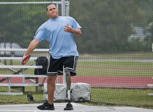 Brian Williams, an Air Force wounded warrior athlete, prepares to throw the discus during the second day of an introductory adaptive sports and rehabilitation camp at Eglin Air Force Base, Fla., April 14, 2015. The Defense Department’s military adaptive sports program enhances warrior recovery by engaging wounded, ill and injured service members in ongoing, daily adaptive activities, based on their interest and ability. (U.S. Air Force photo/Samuel King Jr.)