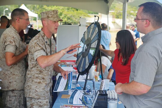 Marines speak with several Marine & Family Programs representatives during the Front Porch event, April 15, 2015, at Dewey Square aboard Marine Corps Base Hawaii. The purpose of the event was to help raise awareness about Marine & Family Programs while, at the same time, promoting cohesion within the community. Aside from the presence of volunteer organizations and Marine Corps Community Services programs, the event had financial classes, activities for children, massages and performances by the U.S. Marine Corps Forces, Pacific Band. (U.S. Marine Corps photo by Lance Cpl. Harley Thomas/Released)
