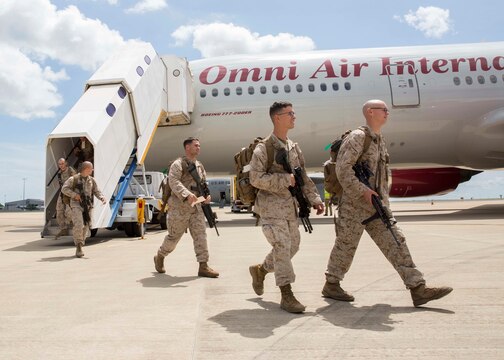 Marines with 1st Battalion, 4th Marine Regiment, Marine Rotational Force - Darwin, exit the aircraft upon arrival to Royal Australian Air Force Base Darwin, Darwin, Australia, April 14 to begin MRF-D 2015. Marines will conduct training at existing Australian Defence Force facilities in the Northern Territory and throughout the region. MRF-D is the deployment of U.S. Marines to Darwin and the Northern Territory, for approximately six months at a time, where they will conduct exercises and training on a rotational basis with the ADF.