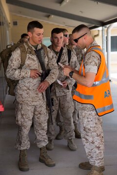 First Lieutenant Duane Blank inspects Marines’ arrival cards April 14 at Royal Australian Air Force Base Darwin, Darwin, Australia. Foreign passengers, both civilian and military, undergo an inspection process with the Australian Customs and Border Protection before entering the country. Marine Rotational Force - Darwin is the deployment of U.S. Marines to Darwin and the Northern Territory, for approximately six months at a time, where they will conduct exercises and training on a rotational basis with the Australian Defence Force. Blank, a White Castle, Louisiana, native, is the executive officer with Company B, 1st Battalion, 4th Marine Regiment, MRF-D.