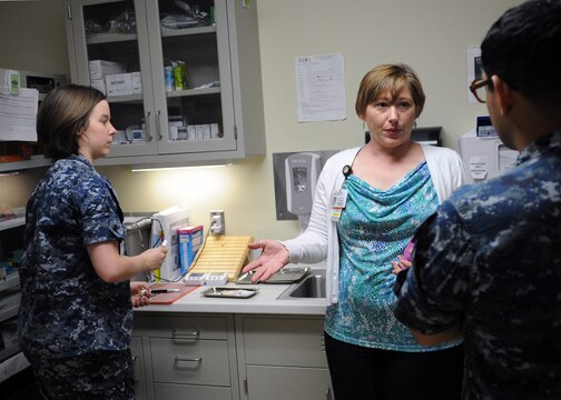 Jennifer Holden, Naval Hospital Camp Pendleton immunizations program nurse manager, discusses proper vaccine processes with sailors working in the NHCP Family Medicine Department’s immunization clinic during a recent survey.