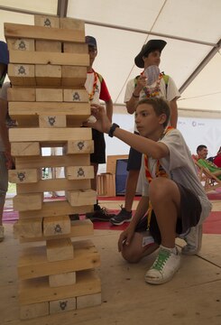 Jamboree participants play a game of Jenga at the Poland Scout tent at the 23rd World Scout Jamboree in Kirara-hama, Yamaguchi, Japan, August 1, 2015. The World Scout Jamboree is a 12-day educational event to promote peace and understanding by inviting scouts from different cultures and backgrounds to come together and share individual experiences.