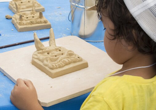 A jamboree participant molds clay at the arts and crafts section of the 23rd World Scout Jamboree in Kirara-hama, Yamaguchi, Japan, August 1, 2015. Among the many attractions were cultural dances, traditional Japanese arts and crafts, science displays and a play area.