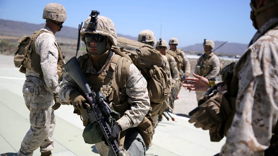 Marines with 3rd Battalion, 5th Marine Regiment, 1st Marine Division run into position prior to boarding a CH-53E Super Stallion before conducting a helicopter raid, as part of the Marine Corps Combat Readiness Evaluation (MCCRE), aboard Marine Corps Base Camp Pendleton, California, Aug. 4, 2015. The MCCRE is used evaluate the operational readiness of a designated unit.
