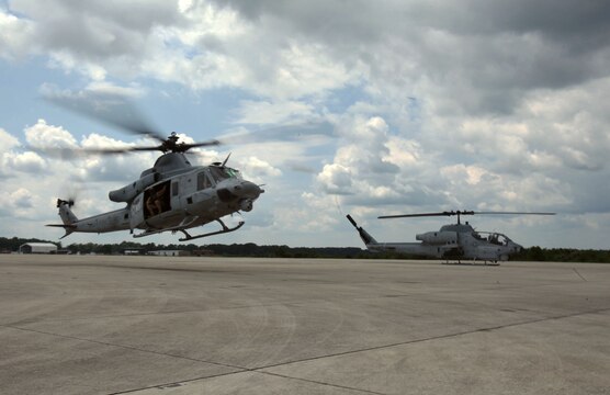 A UH-1Y Huey takes off alongside an AH-1W Super Cobra during a training exercise testing a digital interoperability system at Marine Corps Air Station Cherry Point, North Carolina, July 24, 2015. Digital interoperability is the technology capable of increasing prowess on the battlefield.  The exercise included Marine Light Attack Helicopter Squadron 467, Marine Unmanned Aerial Vehicle Squadron 2, and U.S. Marine Corps Forces, Special Operations Command, testing a LINK 16 conversion system for one of the first times within an explicitly rotary-wing exercise.