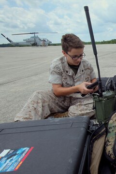 Cpl. Cassie Mousaw operates an AN/PRC-117 G wideband tactical radio and KILSWITCH tablets, during a training exercise testing a digital interoperability system at Marine Corps Air Station Cherry Point, North Carolina, July 24, 2015. Digital interoperability is the technology capable of increasing prowess on the battlefield.  The exercise included Marine Light Attack Helicopter Squadron 467, Marine Unmanned Aerial Vehicle Squadron 2, and U.S. Marine Corps Forces, Special Operations Command, testing a LINK 16 conversion system for one of the first times within an explicitly rotary-wing exercise.  Mousaw is a field radio operator with VMU-2.