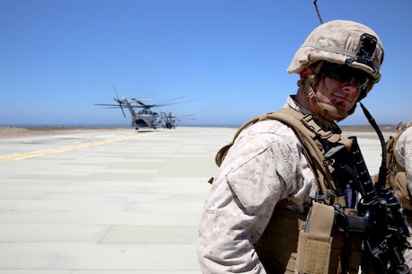 First Lt. Walter Graves II, a platoon commander with 3rd Battalion, 5th Marine Regiment, 1st Marine Division, waits for communication from his radio operator before conducting a helicopter raid as part of the Marine Corps Combat Readiness Evaluation (MCCRE), aboard Marine Corps Base Camp Pendleton, Calif., Aug. 4, 2015. The MCCRE is used evaluate the operational readiness of a designated unit. (U.S. Marine Corps Photo by Cpl. Demetrius Morgan/RELEASED)