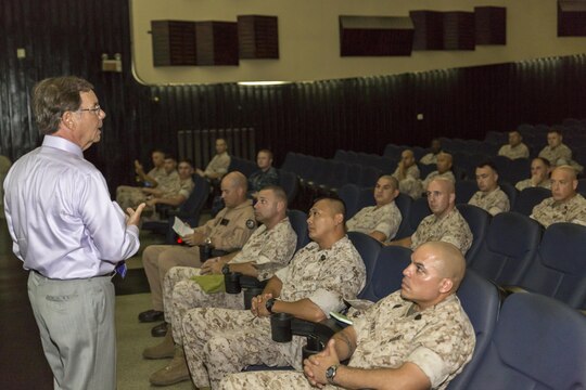 Dr. James P. Hopkins, College of Distance Education and Training Okinawa regional director, briefs staff noncommissioned officers of Marine Corps Air Station Iwakuni, Japan, and Marine Aircraft Group 12 on the Career Course Seminar Distance Education Program, and officers on the Blended Seminar Program at the Sakura Theater aboard station Aug. 5, 2015. The seminar is developed as part of the Marine Corps University’s effort to provide Marines a resident PME experience.