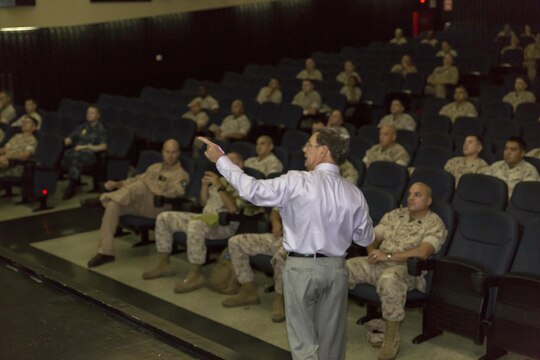 Dr. James P. Hopkins, College of Distance Education and Training Okinawa regional director, briefs staff noncommissioned officers of Marine Corps Air Station Iwakuni, Japan, and Marine Aircraft Group 12 on the Career Course Seminar Distance Education Program, and officers on the Blended Seminar Program at the Sakura Theater aboard station Aug. 5, 2015. Marine Corps University is the professional military education advocate for the Marine Corps, setting policies that affect Marines’ personal and professional education.