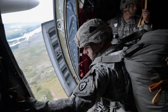 A U.S. Soldier with the 3-509th, 4th Brigade Combat Team (Airborne), 25 Infantry Division, prepares to jump from a C-130 Hercules from Yokota Air Base, Japan, during Red Flag-Alaska at Joint Base Elmendorf-Richardson, Alaska, Aug. 12, 2015. More than 60 U.S. Army Soldiers with the 1-501 Parachute Infantry Regiment and more than 20 Japan Ground Self-Defense Force members jumped from multiple C-130 Hercules during the training. More than 20 allied countries have participated in RED FLAG-Alaska since its conception, improving integration, interoperability and cross-cultural competence. (U.S. Air Force photo by Staff Sgt. Cody H. Ramirez/Released)