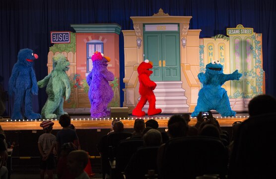 Elmo and friends perform at the Sakura Theater as part of United Services Organization Experience for Military Families at the Sakura Theater aboard Marine Corp Air Station Iwakuni, Japan, Aug. 14, 2015. Military kids can move anywhere from six to nine times before they hit high school. Bringing Elmo and friends directly to them is like bringing a little bit of home away from home.