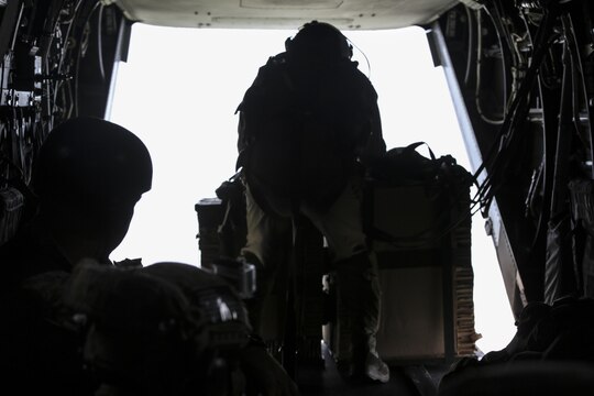 Sgt. Nicholas G. Tissandier, a crew chief with Marine Medium Tiltrotor Squadron 263, prepares to execute an air drop of supplies from an MV-22 Osprey during para-operations above Marine Corps Base Camp Lejeune, N.C., Aug. 18, 2015. Two cargo loads consisting of boxes of meals, ready-to-eat and water containers were air-dropped onto Landing Zone Canary. (U.S. Marine Corps photo by Cpl. Paul S. Martinez/Released)