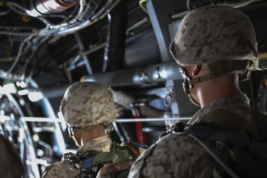 Marine parachute riggers with 2nd Radio Battalion prepare to execute a low level static-line jump from an MV-22 Osprey above Marine Corps Base Camp Lejeune, N.C., Aug. 18, 2015. The Marines jumped form an altitude of 1,250 feet into Landing Zone Canary. (U.S. Marine Corps photo by Cpl. Paul S. Martinez/Released)