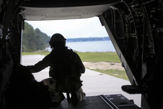 Sgt. Nicholas G. Tissandier, a crew chief with Marine Medium Tiltrotor Squadron 263, oversees the landing of an MV-22 Osprey during para-operations above Marine Corps Base Camp Lejeune, N.C., Aug. 18, 2015. The air crew practiced landings to reflect flight operations in areas of reduced visibility. (U.S. Marine Corps photo by Cpl. Paul S. Martinez/Released)
