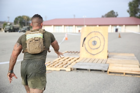A Marine assigned to Company K, 3rd Battalion, 5th Marine Regiment, 1st Marine Division, throws a knife at a target as part of the Dark Horse Ajax Challenge aboard Marine Corps Base Camp Pendleton, Calif., Aug. 20, 2015. The eight-mile course tested the Marines’ and Sailors’ endurance and leadership skills with trials spread across the San Mateo area. (U.S. Marine Corps photo by Cpl. Will Perkins)
