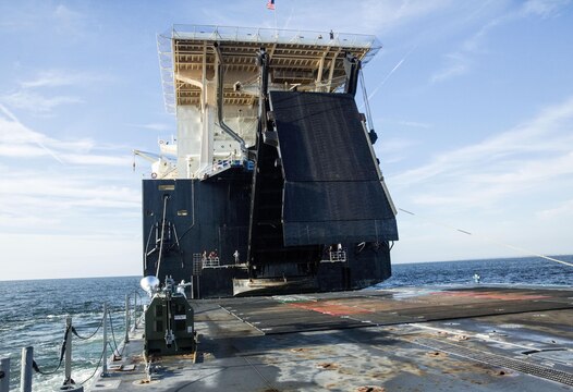 A ramp is lowered from the USNS 1st Lt. Jack Lummus to a Roll-on/Roll-off Discharge Facility (RRDF), during an in-stream Marine Prepositioning Force Exercise, Aug. 19, 2015. The ramp allowed Marines with Combat Logistics Regiment 25 to drive equipment off the Lummus onto the RRDF and Improved Navy Lighterage Systems, where it was then transferred to Marine Corps Support Facility Blount Island, Fla. (U.S. Marine Corps photo by Sgt. Shawn Valosin/Released)