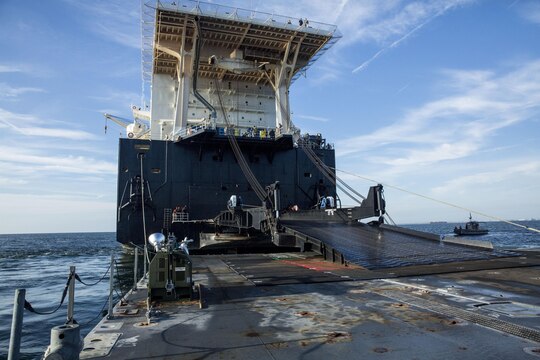 A ramp attached to the USNS 1st Lt. Jack Lummus rests on a Roll-on/Roll-off Discharge Facility (RRDF), during an in-stream Marine Prepositioning Force Exercise, Aug. 19, 2015. The ramp allowed Marines with Combat Logistics Regiment 25 to drive equipment off the Lummus onto the RRDF and Improved Navy Lighterage Systems, where it was then transferred to Marine Corps Support Facility Blount Island, Fla. (U.S. Marine Corps photo by Sgt. Shawn Valosin/Released)