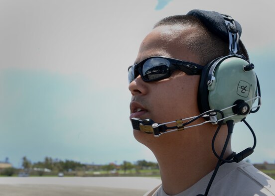 U.S. Air Force Staff Sgt. Mark Lopez, 509th Aircraft Maintenance Squadron avionics craftsman deployed from Whiteman Air Force Base, Missouri, speaks with aircrew during takeoff preparations at Andersen Air Force Base, Guam, Aug. 17, 2015. Lopez communicated with the pilots to ensure the steering on a B-2 Spirit worked properly prior to the bomber departing the flightline. (U.S. Air Force photo by Senior Airman Joseph A. Pagán Jr./Released)