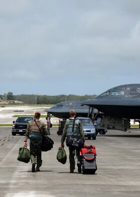 Aircrew from Whiteman Air Force Base, Missouri, walk toward a B-2 Spirit at Andersen Air Force Base, Guam, Aug. 17, 2015. Bomber training missions support the nation’s ability to maintain a strong, credible strategic force and enhance and provide for the security and stability of Allies and partners. (U.S. Air Force photo by Senior Airman Joseph A. Pagán Jr./Released)