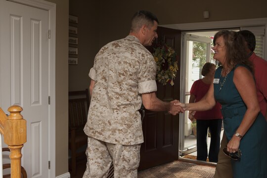 U.S. Marine Corps Maj. Gen. William D. Beydler, II Marine Expeditionary Force (II MEF) Commanding General, welcomes guests into his home to promote the Protect What You've Earned campaign on Camp Lejeune, N.C., Aug. 25, 2015. The campaign was created to encourage Marines to make the right decisions on and off duty. (U.S. Marine Corps photo by Lance Cpl. Sarah L. Blendowski, 2DMARDIV Combat Camera/Released)