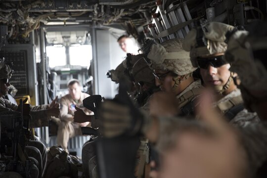 Marines with 2nd Battalion, 1st Marine Regiment, put their thumbs up after securing themselves into an MV-22B Osprey during egress training aboard Marine Corps Base Camp Pendleton, California, Aug. 18. Marines conducted the training drills as part of predeployment training for the 13th Marine Expeditionary Unit. (U.S. Marine Corps photo by Sgt. Lillian Stephens/Released)