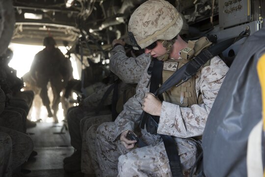 Marines with 2nd Battalion, 1st Marine Regiment, secure themselves into an MV-22B Osprey with Marine Medium Tiltrotor Squadron (VMM) 166 (Reinforced) during egress training aboard Marine Corps Base Camp Pendleton, California, Aug. 18. Marines conducted the training as part of the 13th Marine Expeditionary Unit predeployment training. (U.S. Marine Corps photo by Sgt. Lillian Stephens/Released)