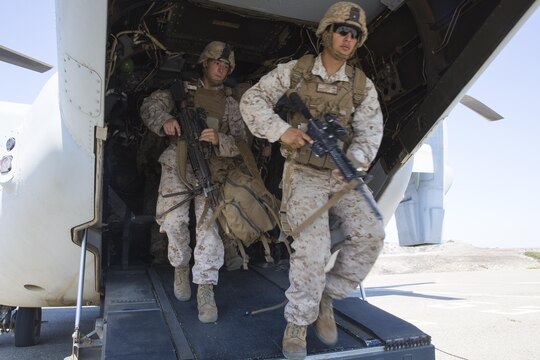 Marines with 2nd Battalion, 1st Marine Regiment exit an MV-22B Osprey with Marine Medium Tiltrotor Squadron (VMM) 166 (Reinforced) during egress training aboard Marine Corps Base Camp Pendleton, California, Aug. 18.  Marines conducted the training as part of the 13th Marine Expeditionary Unit predeployment training. (U.S. Marine Corps photo by Sgt. Lillian Stephens/Released)