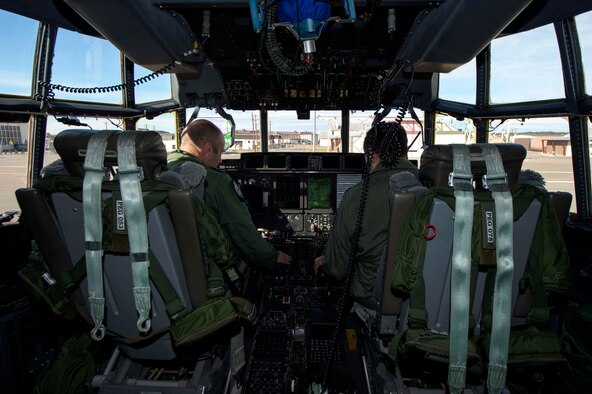 Royal Air Force Flight Lt. Graeme Hunt assigned to No. 37 Squadron and Royal Australian Air Force Flight Lt. Andreas Constantinou perform a pre-flight check on a C-130J Super Hercules before take-off during Pacific Airlift Rally on Aug. 25, 2015, at Joint Base Elmendorf-Richardson, Alaska. Pacific Airlift Rally is a biennial, military airlift symposium sponsored by Pacific Air Forces for nations in the Indo-Asia-Pacific region. PAR 15 uses a Humanitarian Assistance/Disaster Relief scenario to provide participating nations the opportunity to cooperate, interact, and advance airlift to topics specific to the region. (U.S. Air Force photo by Staff Sgt. Sheila deVera/Released)