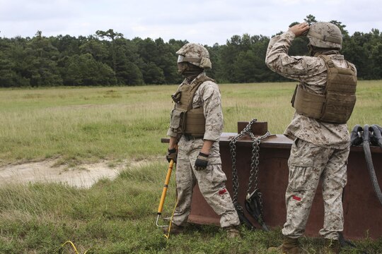 Marines with 2nd Transportation Support Battalion await the arrival of a CH-53E Super Stallion during an external lift exercise aboard Camp Lejeune, N.C., Aug. 25, 2015. As a CH-53E hovered several yards above, on-the-ground Marines worked together to attach a beam weighing 8,500 pounds to the aircraft’s cable. (U.S. Marine Corps photo by Cpl. Paul S. Martinez/Released)