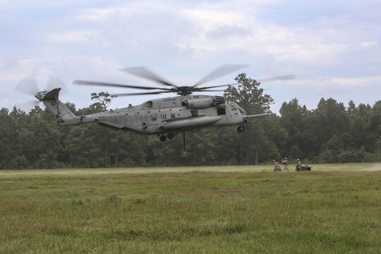 Marine pilots in a CH-53E Super Stallion with Marine Heavy Helicopter Training Squadron 302, descend for Marines with 2nd Transportation Support Battalion, during an external lift exercise aboard Camp Lejeune, N.C., Aug. 25, 2015. Marines on the ground worked together to attached a beam weighing 8,500 pounds to the aircraft’s pintle hook. (U.S. Marine Corps photo by Cpl. Paul S. Martinez/Released)