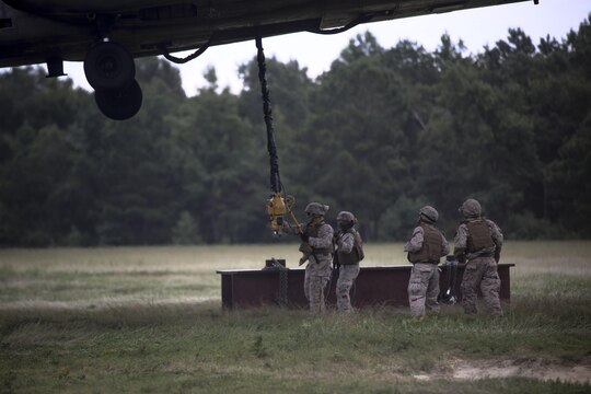 Marines with 2nd Transportation Support Battalion prepare to attach an 8,500-pound high beam to a pintle hook beneath a CH-53E Super Stallion during an external lift exercise aboard Camp Lejeune, N.C., Aug. 25, 2015. The 8,500 pound beam is only a fraction of the maximum 32,000 pounds the aircraft is capable of carrying. (U.S. Marine Corps photo by Cpl. Paul S. Martinez/Released)