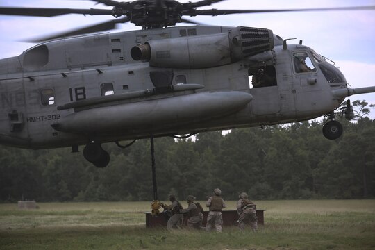 Marines with 2nd Transportation Support Battalion prepare to attach an 8,500-pound high beam to a pintle hook beneath a CH-53E Super Stallion during an external lift exercise aboard Camp Lejeune, N.C., Aug. 25, 2015. The 8,500 pound beam is only a fraction of the maximum 32,000 pounds the aircraft is capable of carrying. (U.S. Marine Corps photo by Cpl. Paul S. Martinez/Released)