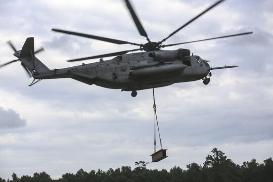 Marine pilots in a CH-53E Super Stallion with Marine Heavy Helicopter Training Squadron 302, carry away an 8,500-pound high beam during an external lift exercise aboard Camp Lejeune, N.C., Aug. 25, 2015. As the CH-53E hovered several yards above, on-the-ground Marines worked together to attach a beam weighing 8,500 pounds to the aircraft’s cable. (U.S. Marine Corps photo by Cpl. Paul S. Martinez/Released)