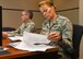 Lt. Col. Thomas Moore, Air Force Medical Support Agency chief of health promotions, and Maj. Marella Big Mountain, from the Profession of Arms Center of Excellence, review Master Resilience Trainer Course information at the U.S. Air Force Expeditionary Center, Aug. 13. The MRTC, taught at the USAFEC, underwent an Instructional System Design review with credentialed Airmen whose professions align with the Comprehensive Airmen Fitness model of Mental, Physical, Social, and Spiritual domains. (U.S. Air Force photo/Bradley Camara)