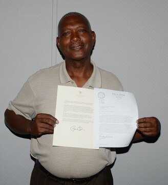 Retired Marine Master GySgt. Randolph Scott, project administrator, Marine Corps Systems Command, displays his commendation letters from President Barak Obama and Mayor Dorothy Hubbard, Albany, Ga., recently. Each of the awards recognized Scott for his “outstanding” volunteer service to children, the community as well as to veteran service members. Scott has earned a total of six President’s Volunteer Service Awards and was, recently, nominated to receive the Registered Adult Volunteer of the Year Award by Mayor Hubbard.

