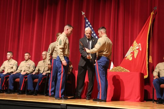 The Honor Graduate is presented a noncommissioned officer’s sword at the Corporals Course 2-16 graduation aboard Marine Corps Air Station Miramar, California, Dec. 10. Corporals Course, a professional military education program hosted by 3rd Marine Aircraft Wing, is a re-introduction of the basic Marine Corps values to noncommissioned officers.(U.S. Marine Corps photo by Lance Cpl. Harley Robinson/Released)